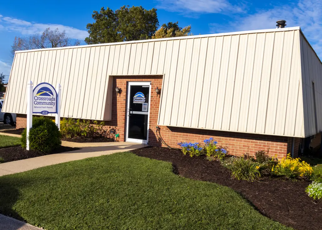 Rivers Crossing Wellness Community office in Cambridge, Maryland with a landscaped entrance and white siding.