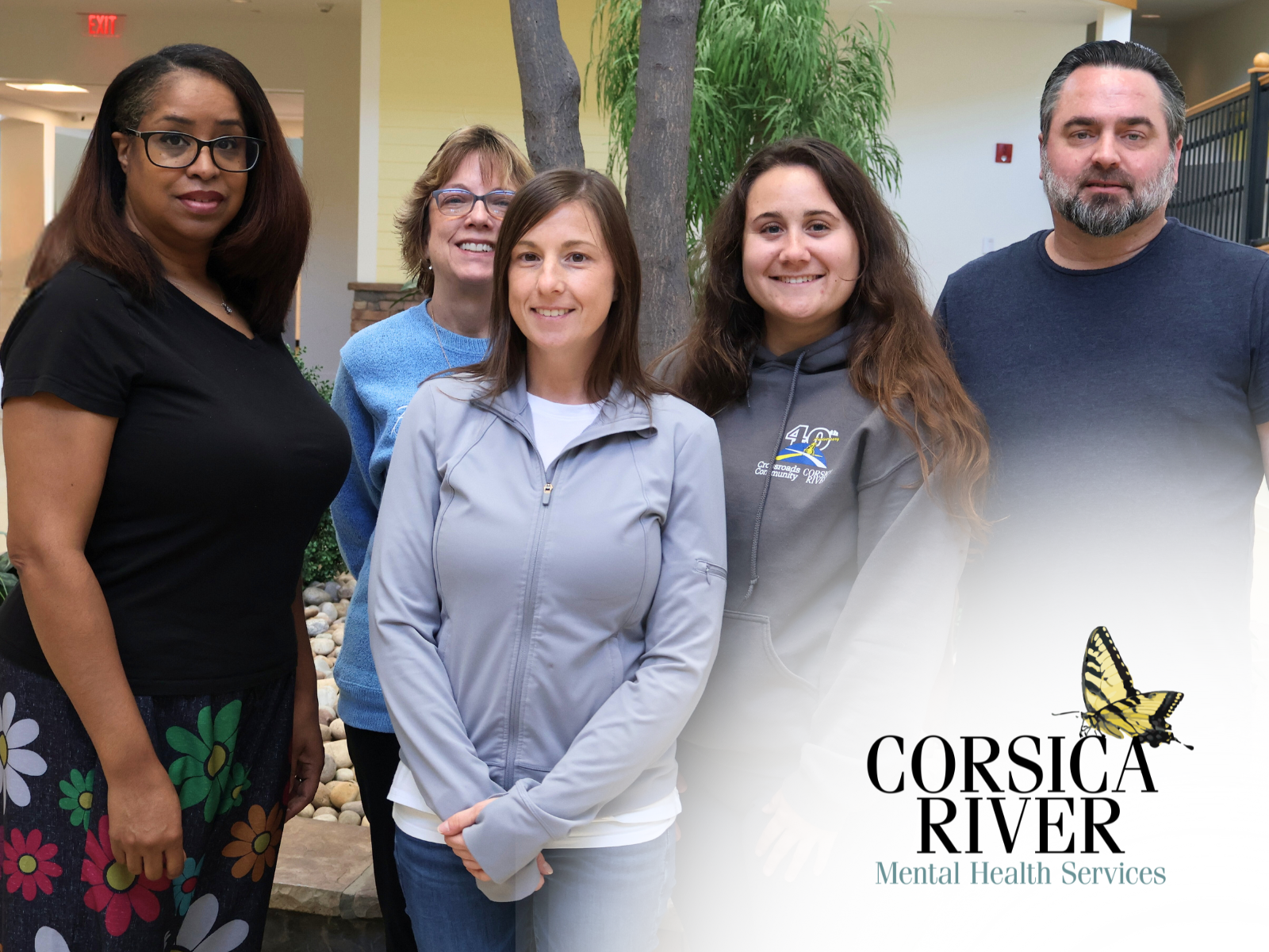Group of Corsica River Mental Health Services staff members smiling with organizational logo