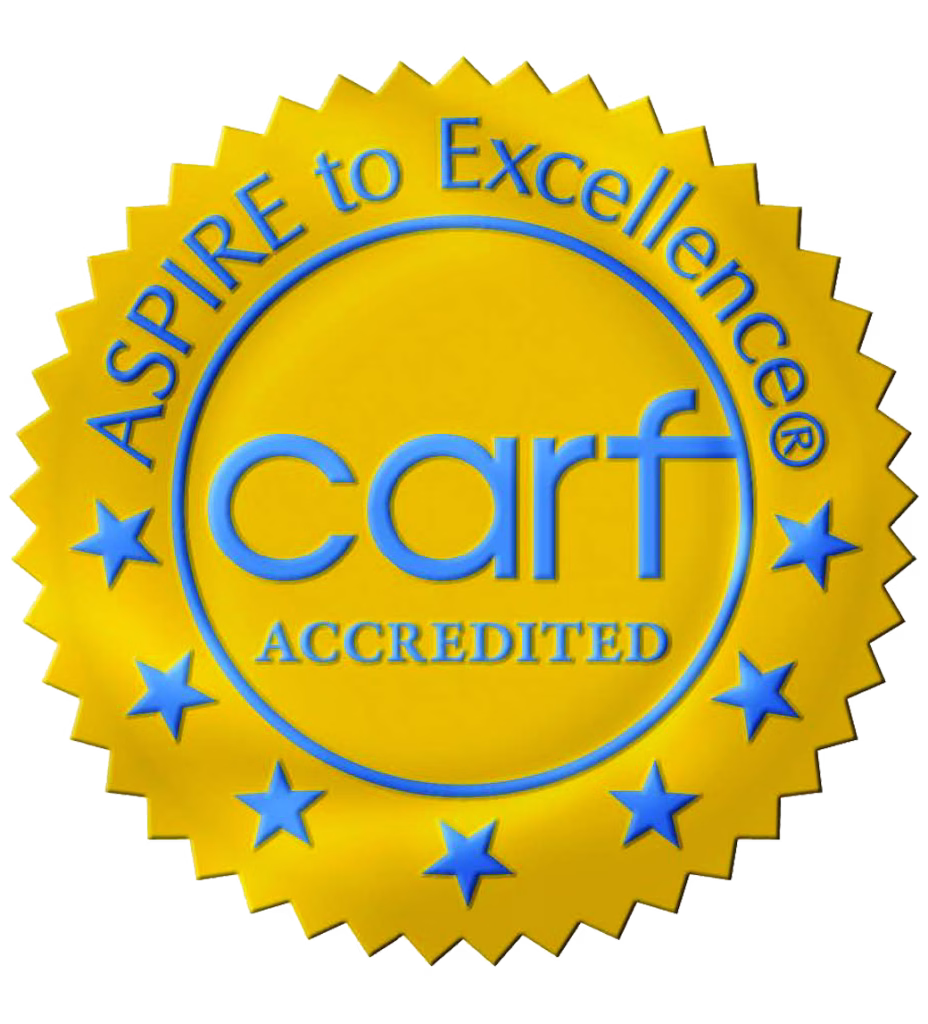 CARF International accreditation seal with Aspire to Excellence motto and stars around the logo